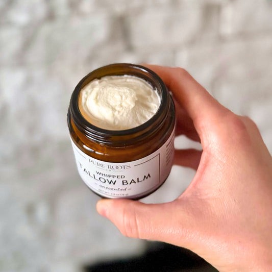 Hand holding a jar of 'Whipped Willow Balm' with a blurred background