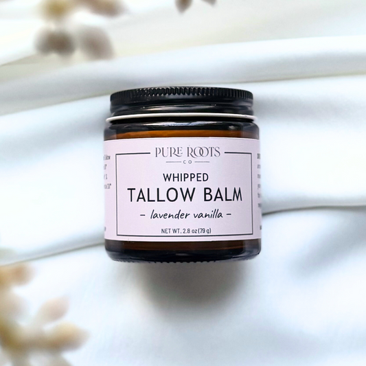 Jar of whipped tallow balm with a label on a light background